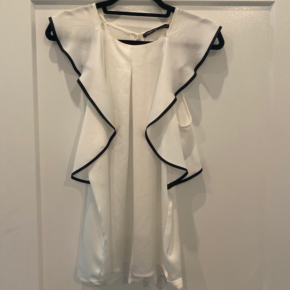 White blouse with black ruffles